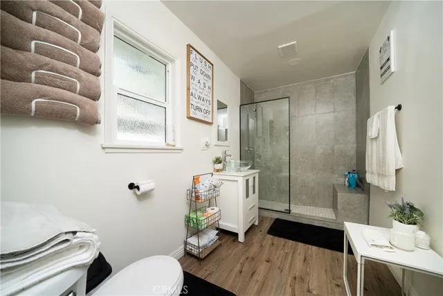 a bathroom with a sink toilet and shower
