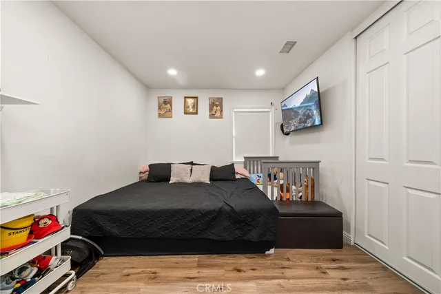 a bedroom with a bed and a view of kitchen