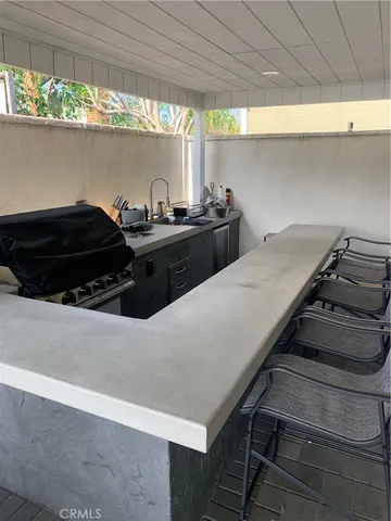 a kitchen with a stove and a window