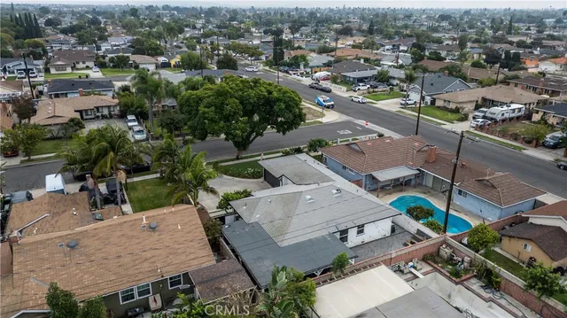 an aerial view of a house with a yard and lake view