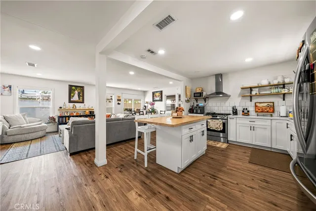 a kitchen with sink cabinets and wooden floor