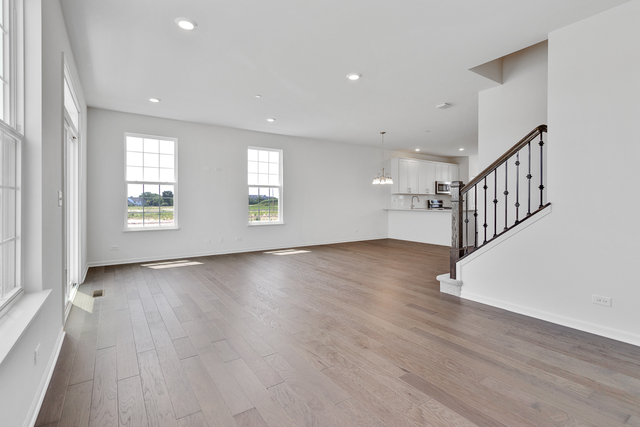 1652 Kraft Avenue Batavia, IL 60510 - Photo 13 of 25 a view of an empty room with wooden floor and a window