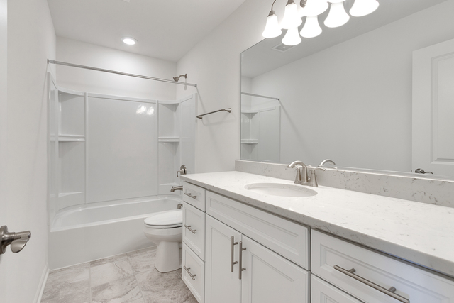 1652 Kraft Avenue Batavia, IL 60510 - Photo 20 of 25 a bathroom with a granite countertop sink a toilet and bathtub