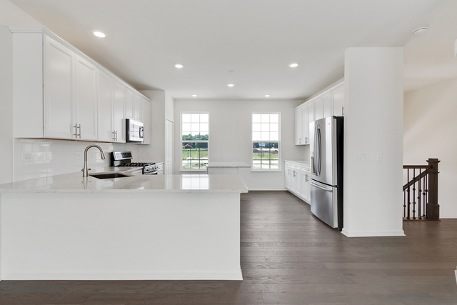 1652 Kraft Avenue Batavia, IL 60510 - Photo 4 of 25 a kitchen with stainless steel appliances granite countertop a refrigerator sink and white cabinets