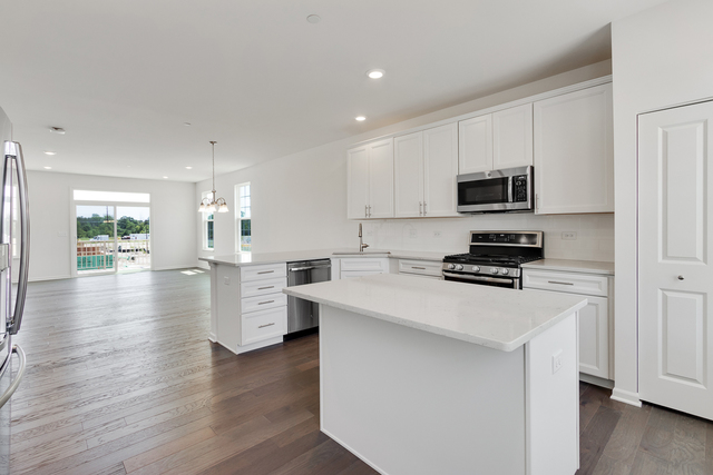 1652 Kraft Avenue Batavia, IL 60510 - Photo 8 of 25 a kitchen with kitchen island granite countertop a stove top oven a sink a counter space and cabinets