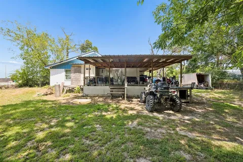 a view of a house with backyard porch and sitting area