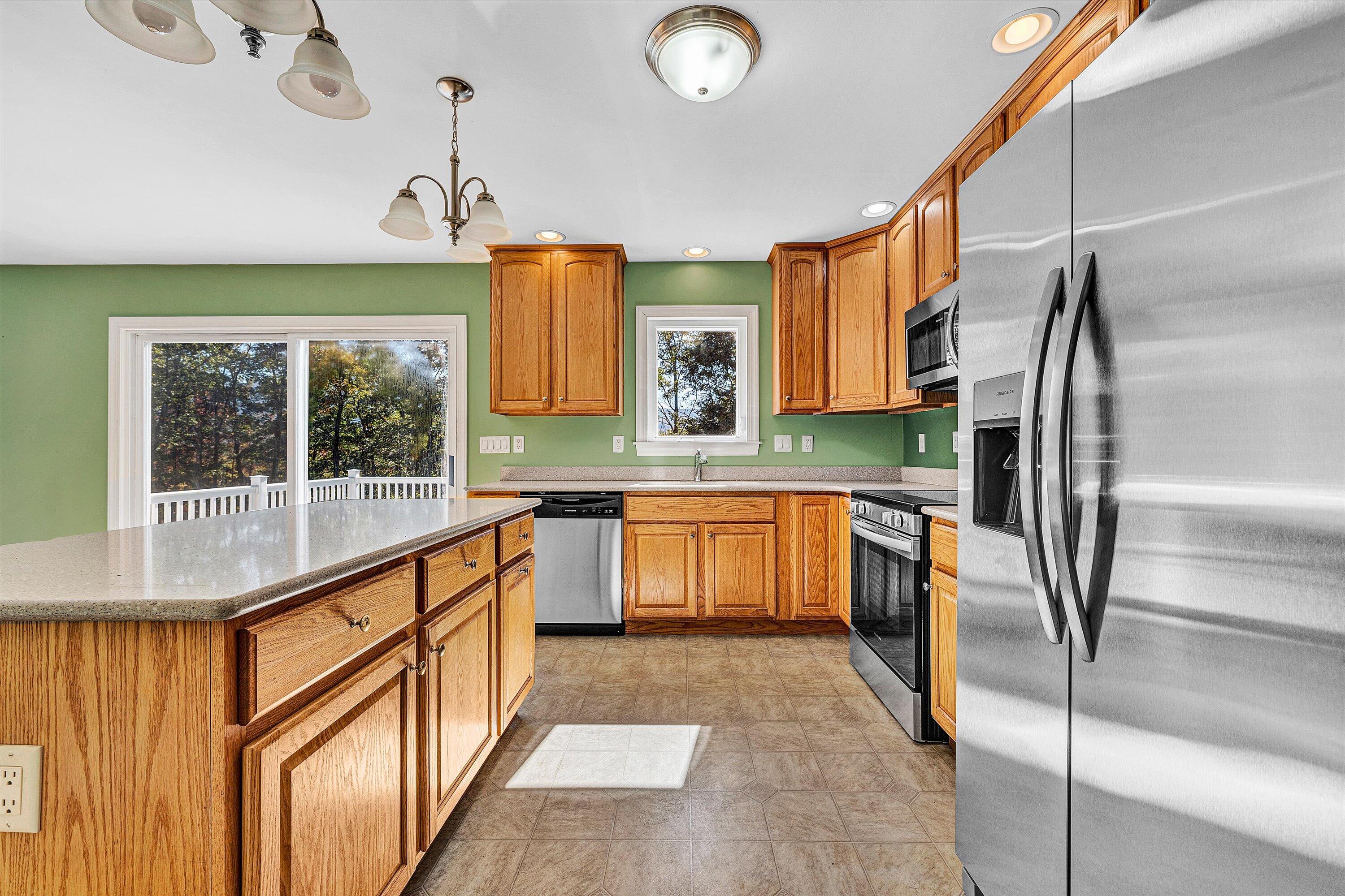 401 Piney Ridge Road Covington, VA 24426 - Photo 13 of 83 a kitchen with stainless steel appliances granite countertop a sink refrigerator and cabinets