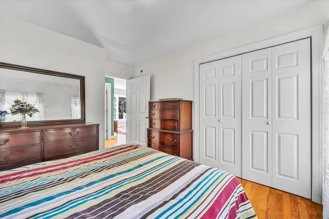 an empty room with a window and ceiling fan