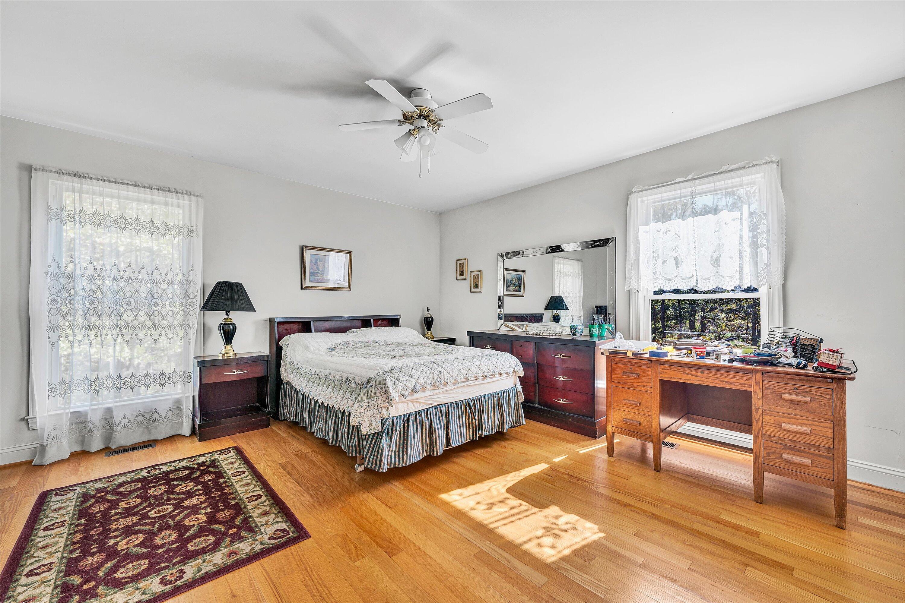 401 Piney Ridge Road Covington, VA 24426 - Photo 23 of 83 a spacious bedroom with a bed and wooden floor