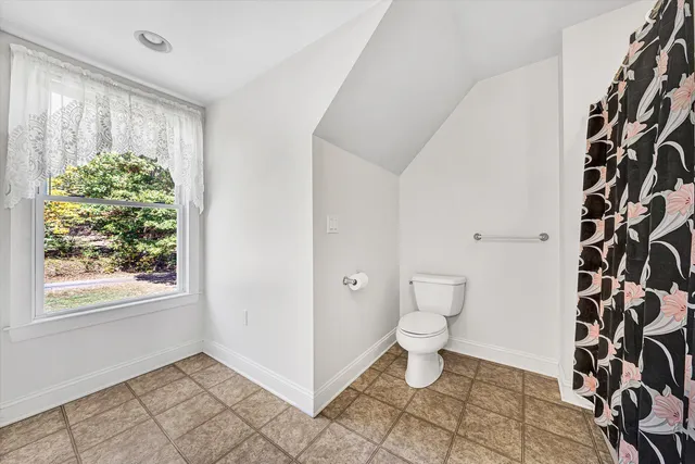a bathroom with a shower curtain and a curtain