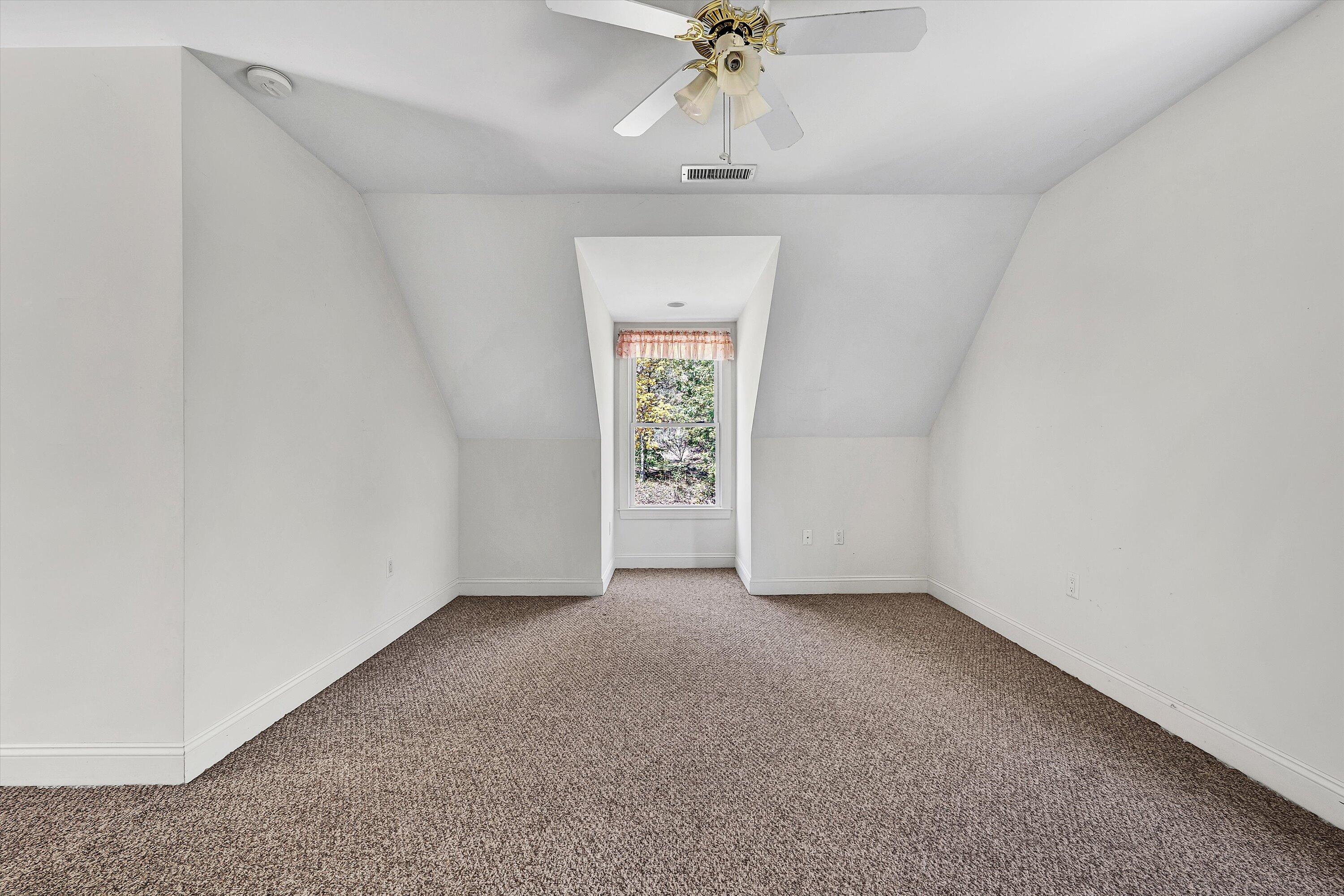 401 Piney Ridge Road Covington, VA 24426 - Photo 34 of 83 an empty room with a chandelier fan and windows