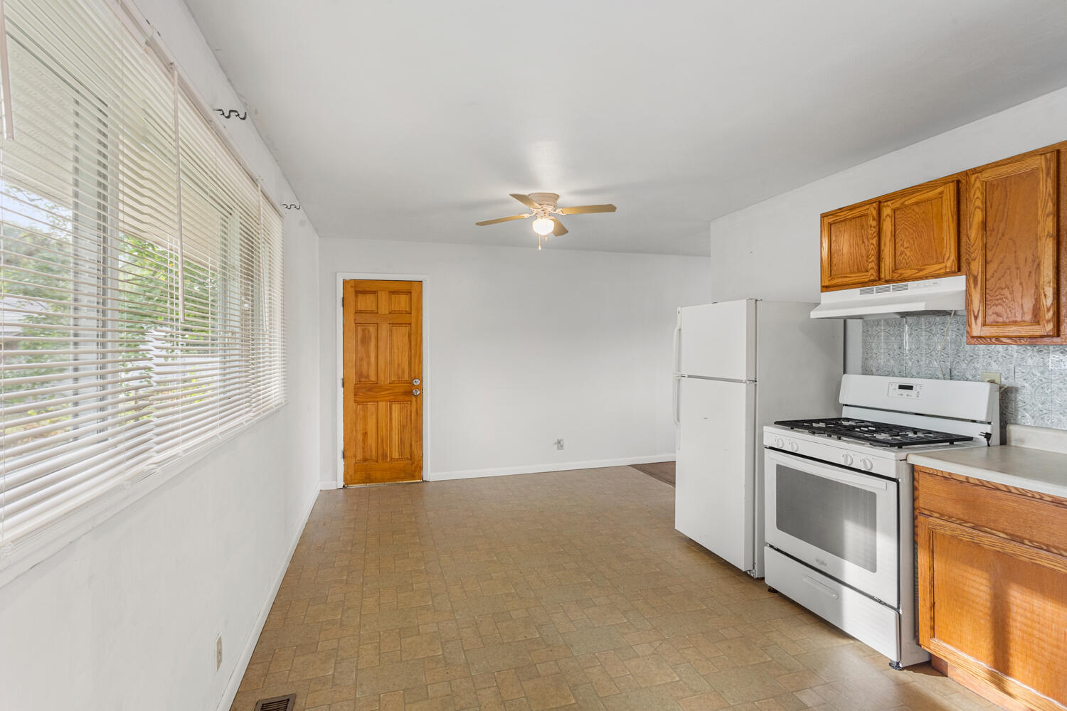 1504 North Mattis Avenue Champaign, IL 61821 - Photo 12 of 21 a kitchen with a stove a sink and a refrigerator