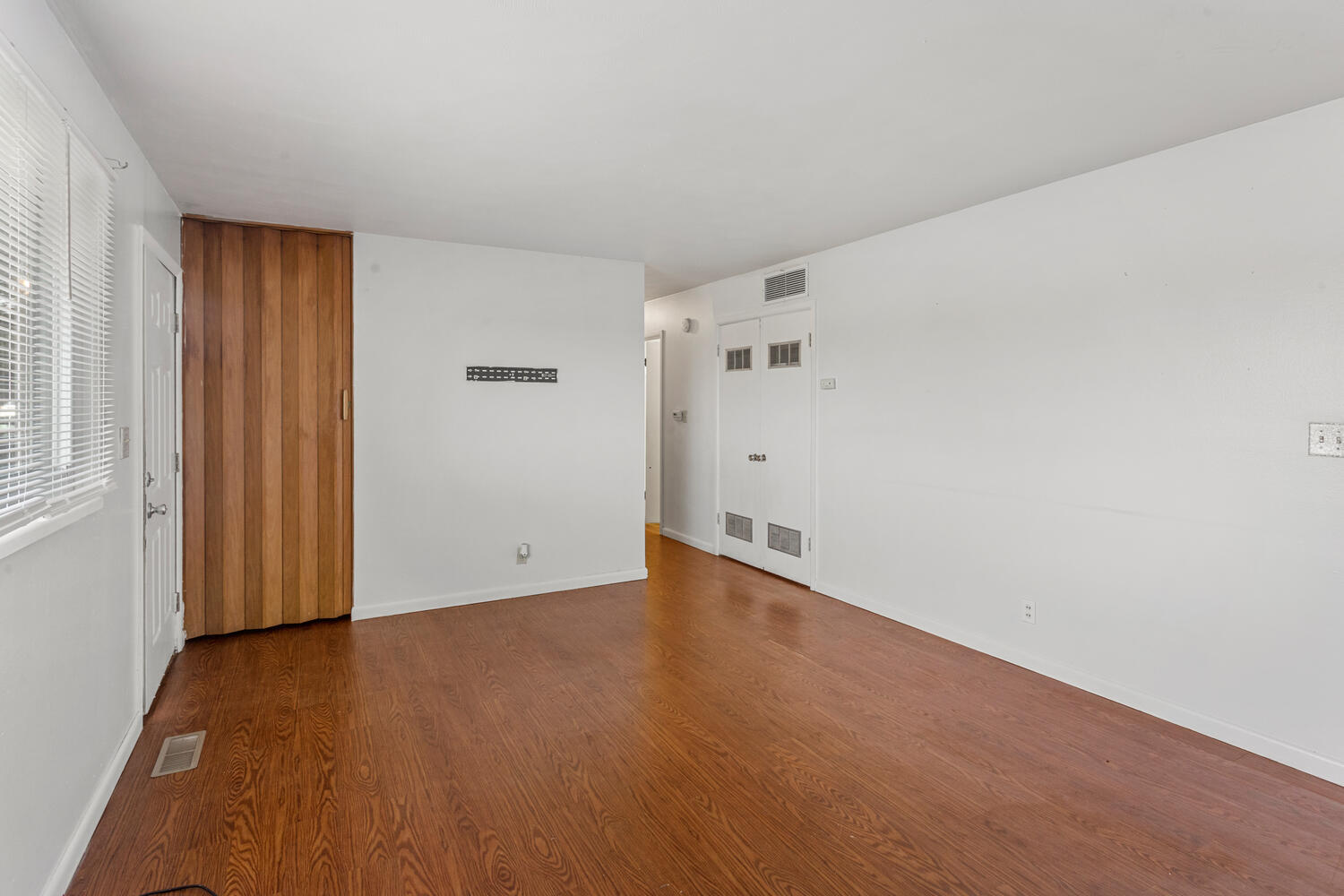 1504 North Mattis Avenue Champaign, IL 61821 - Photo 8 of 21 a view of an empty room with wooden floor and a window