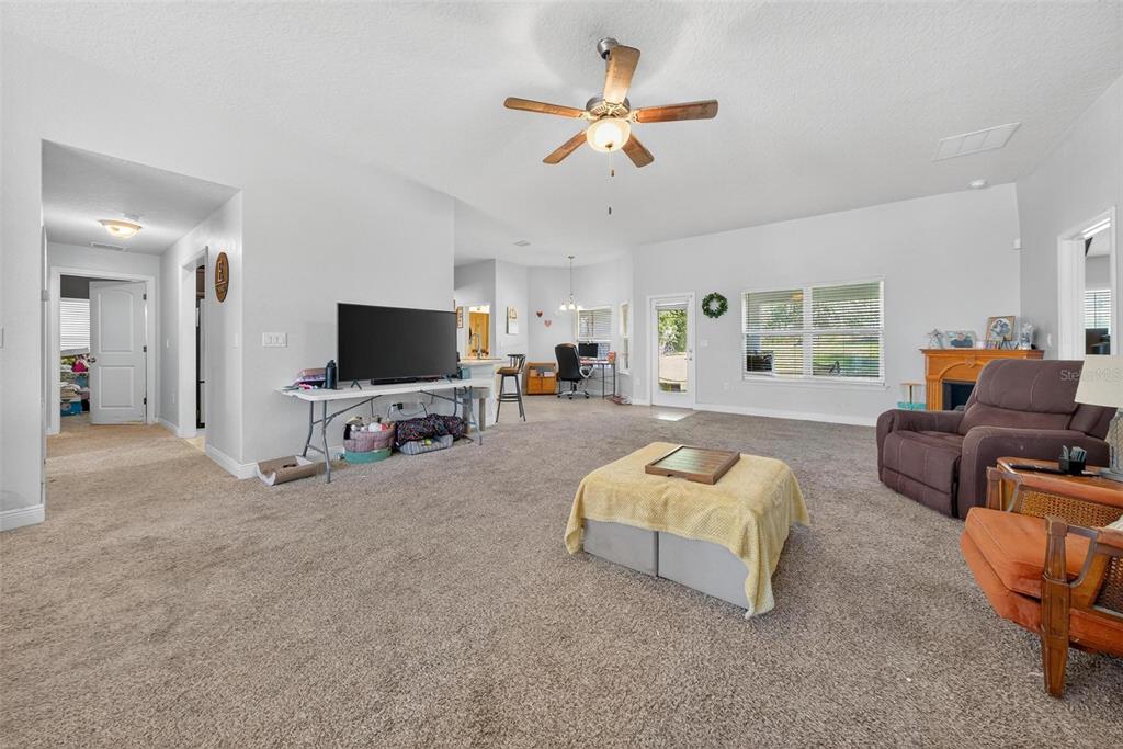2005 Angel Fish Loop Leesburg, FL 34748 - Photo 11 of 54 a living room with furniture and a flat screen tv