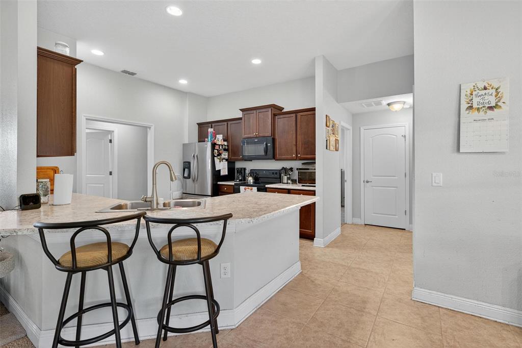 2005 Angel Fish Loop Leesburg, FL 34748 - Photo 20 of 54 a kitchen with stainless steel appliances a refrigerator and a stove top oven