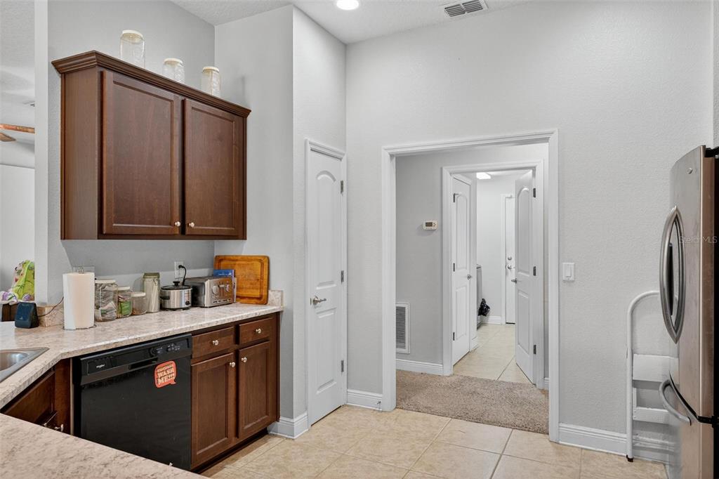2005 Angel Fish Loop Leesburg, FL 34748 - Photo 23 of 54 a kitchen with stainless steel appliances granite countertop a refrigerator and a sink