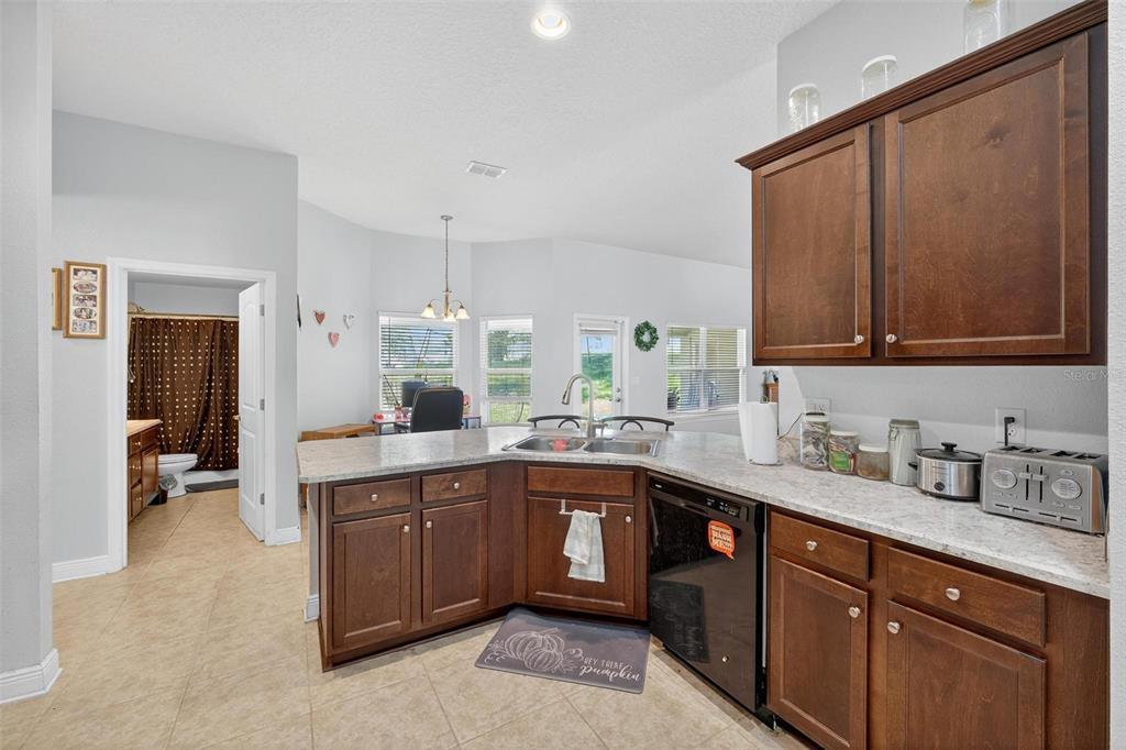 2005 Angel Fish Loop Leesburg, FL 34748 - Photo 24 of 54 a kitchen with a sink stove and cabinets