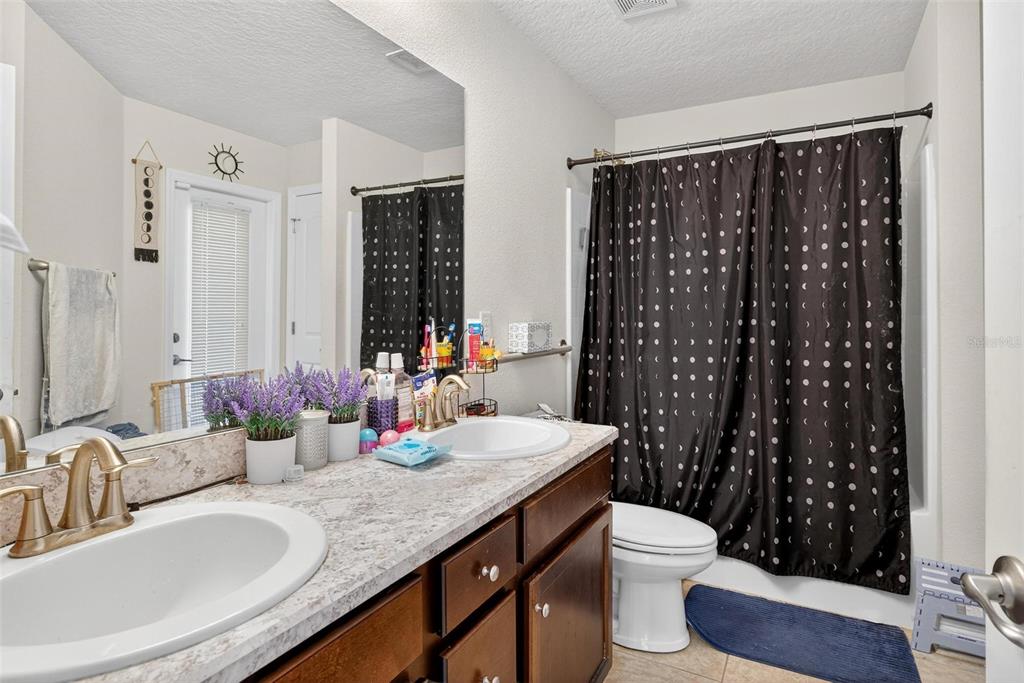 2005 Angel Fish Loop Leesburg, FL 34748 - Photo 27 of 54 a bathroom with a granite countertop sink and a mirror