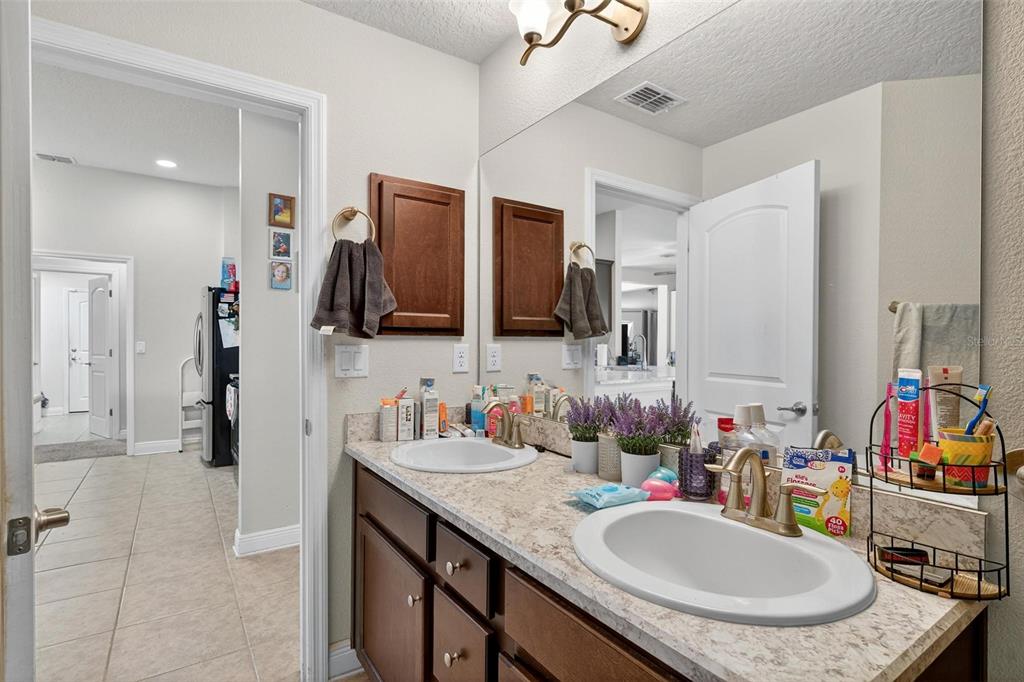 2005 Angel Fish Loop Leesburg, FL 34748 - Photo 28 of 54 a bathroom with a granite countertop sink a mirror and a toilet