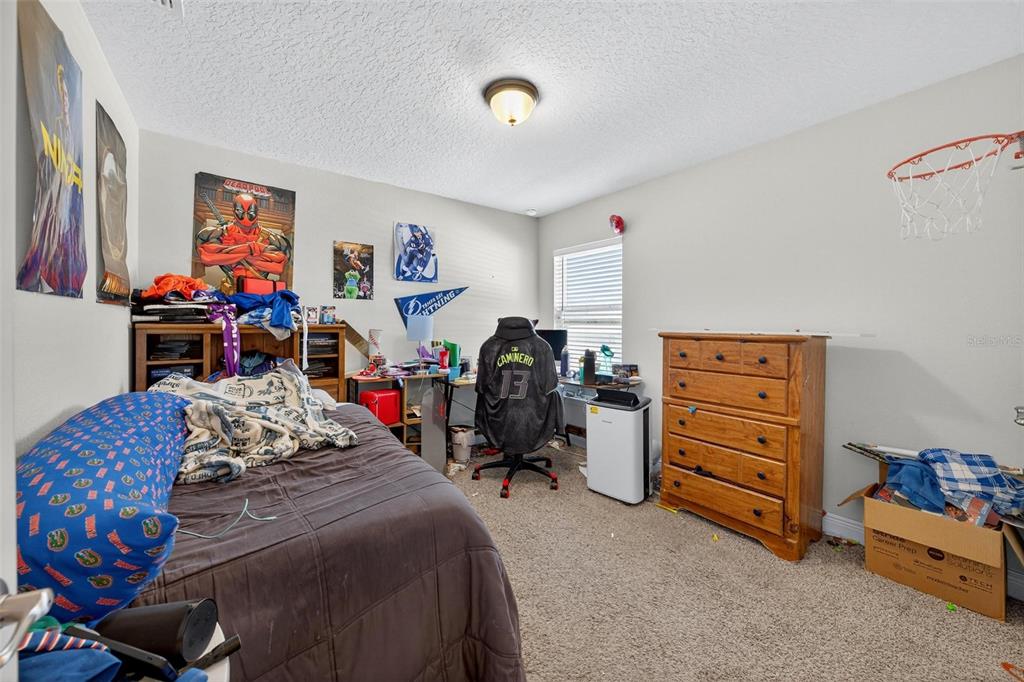 2005 Angel Fish Loop Leesburg, FL 34748 - Photo 31 of 54 a bed room with a bed and a chair