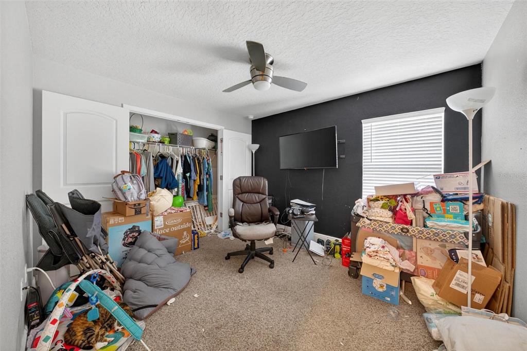 2005 Angel Fish Loop Leesburg, FL 34748 - Photo 36 of 54 a bedroom with furniture and a window