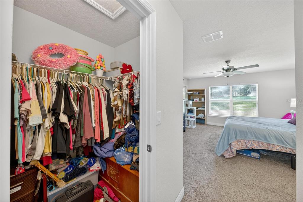 2005 Angel Fish Loop Leesburg, FL 34748 - Photo 44 of 54 a view of walk in closet with clothes and shoes