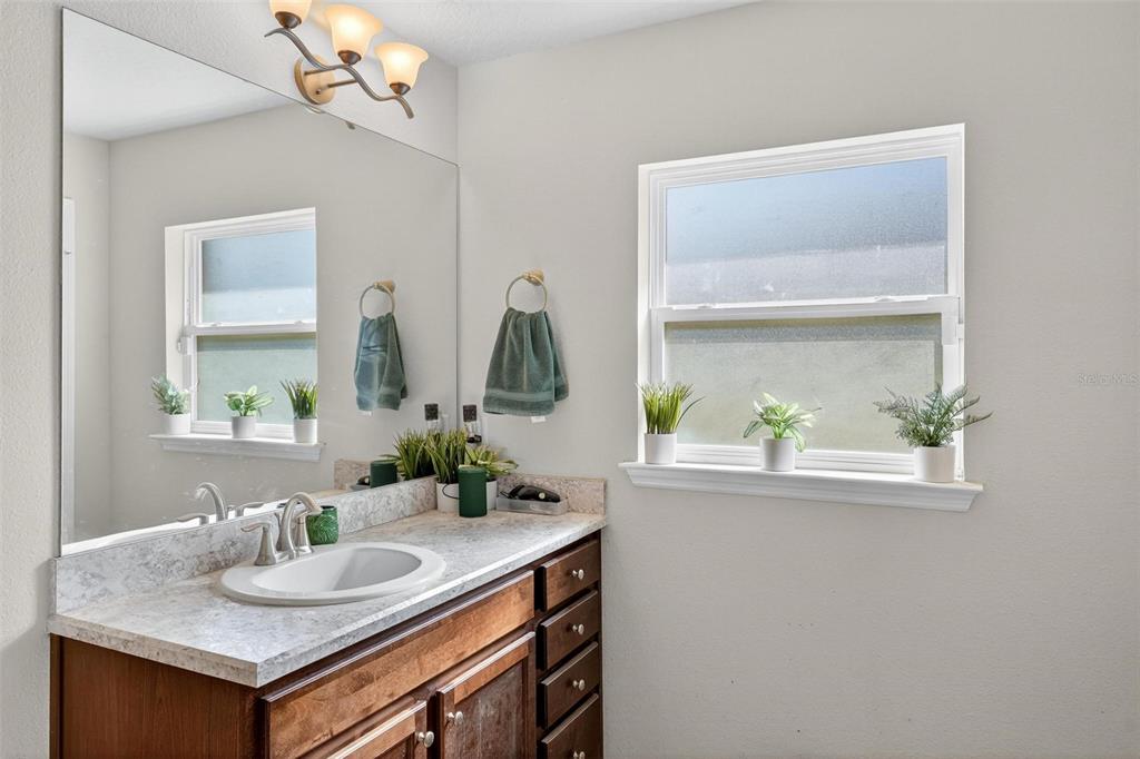 2005 Angel Fish Loop Leesburg, FL 34748 - Photo 48 of 54 a bathroom with a sink and a mirror