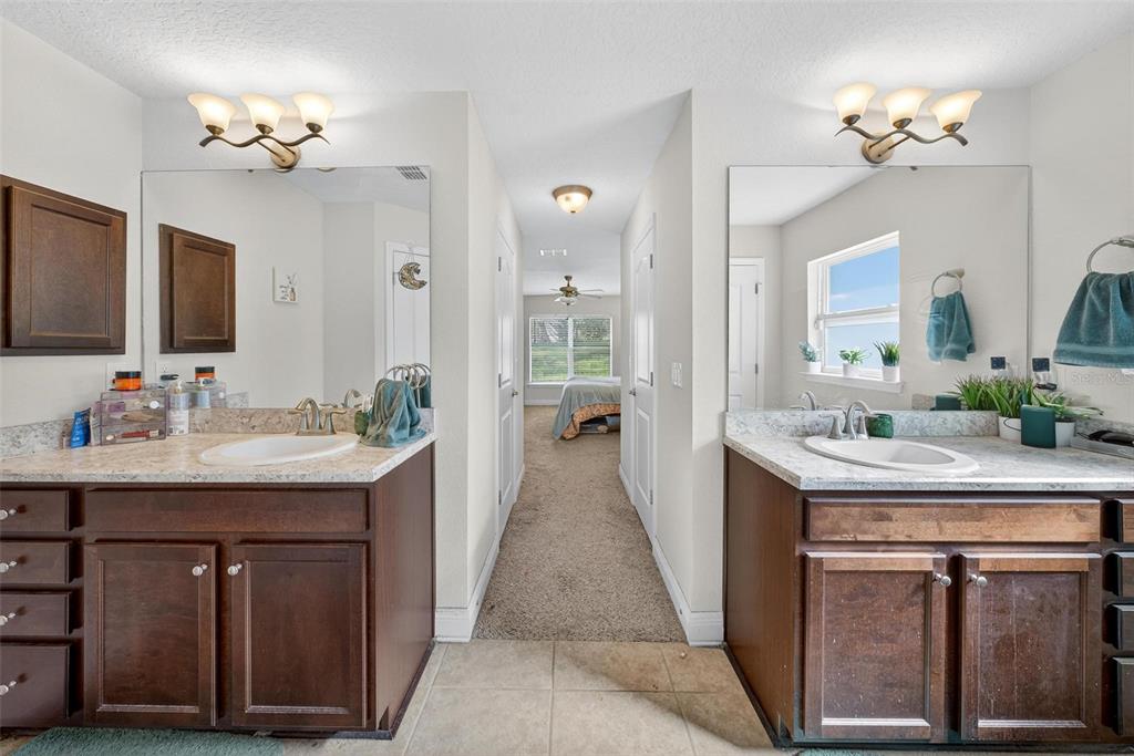 2005 Angel Fish Loop Leesburg, FL 34748 - Photo 49 of 54 a en suite bathroom with a sink double vanity granite and a mirror