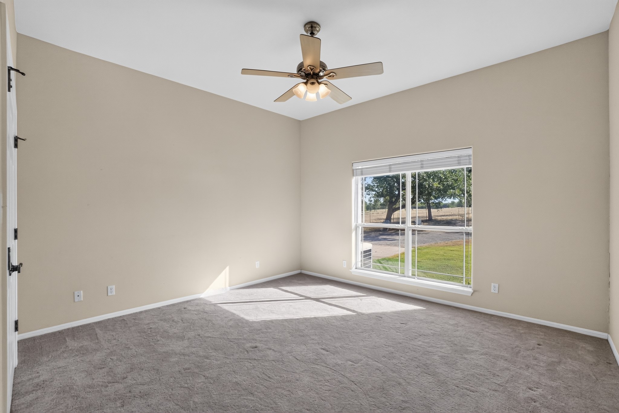 986 High Grove Road Cedar Creek, TX 78612 - Photo 21 of 30 High ceilings and neutral plush carpeting define this versatile secondary bedroom space.