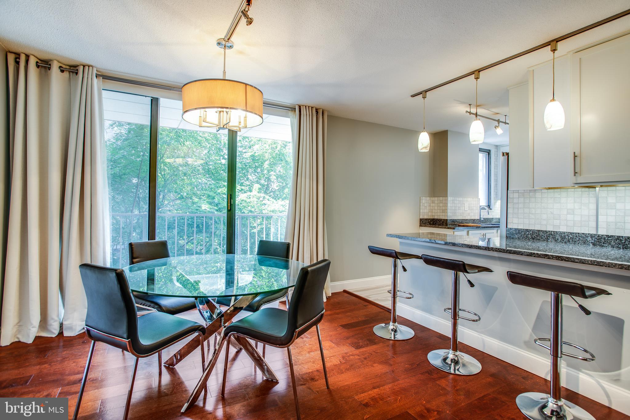 2201 L Street Northwest, Unit 500 Washington, DC 20037 - Photo 1 of 43 a dining room with furniture and wooden floor