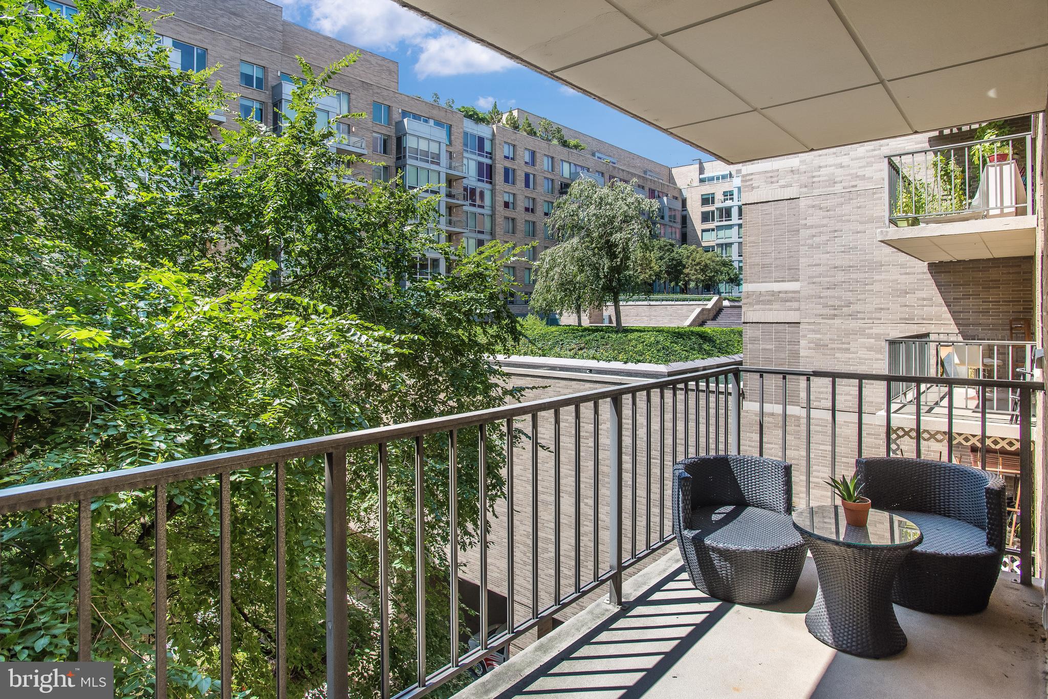 2201 L Street Northwest, Unit 500 Washington, DC 20037 - Photo 12 of 43 a view of a chair and tables in the balcony