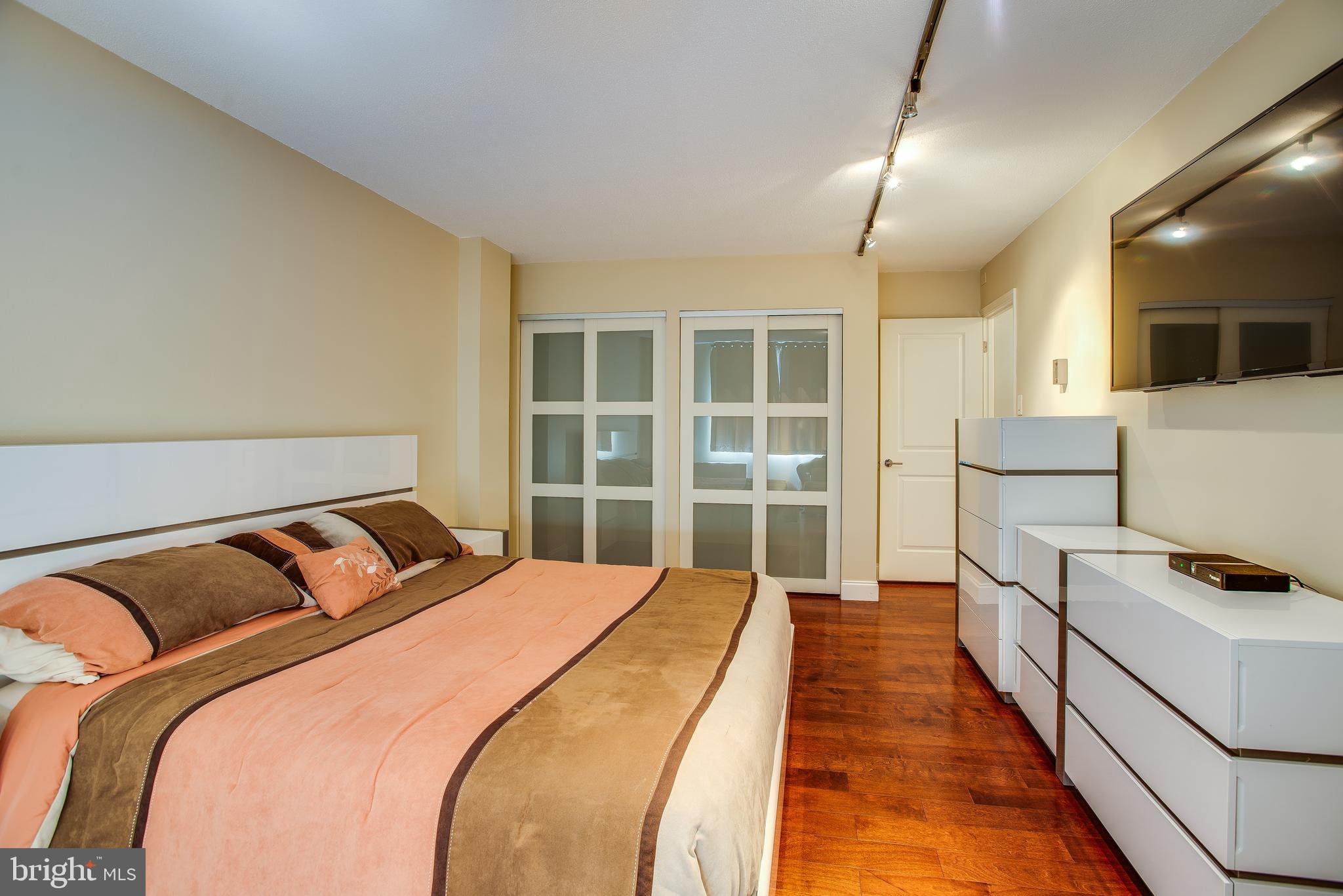 2201 L Street Northwest, Unit 500 Washington, DC 20037 - Photo 16 of 43 a bedroom with a bed and a view of balcony