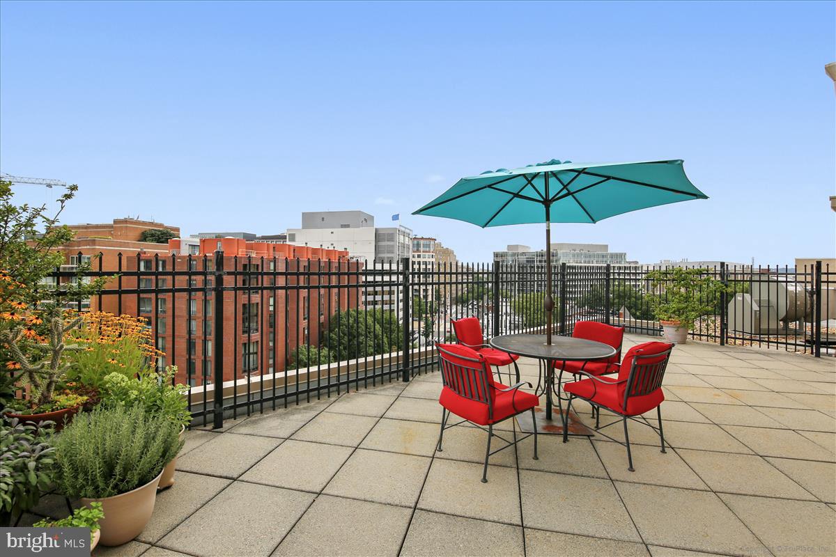2201 L Street Northwest, Unit 500 Washington, DC 20037 - Photo 26 of 43 a view of a terrace with furniture and umbrella
