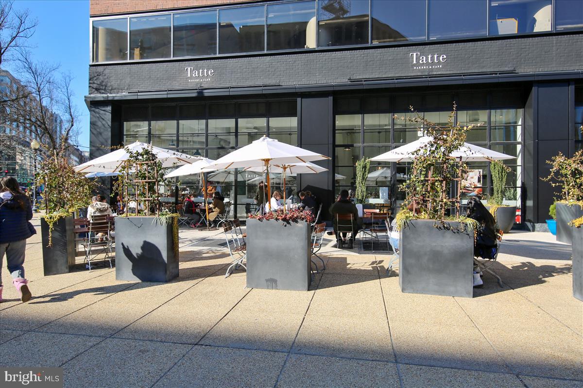 2201 L Street Northwest, Unit 500 Washington, DC 20037 - Photo 41 of 43 a view of a patio with a table and chairs under an umbrella