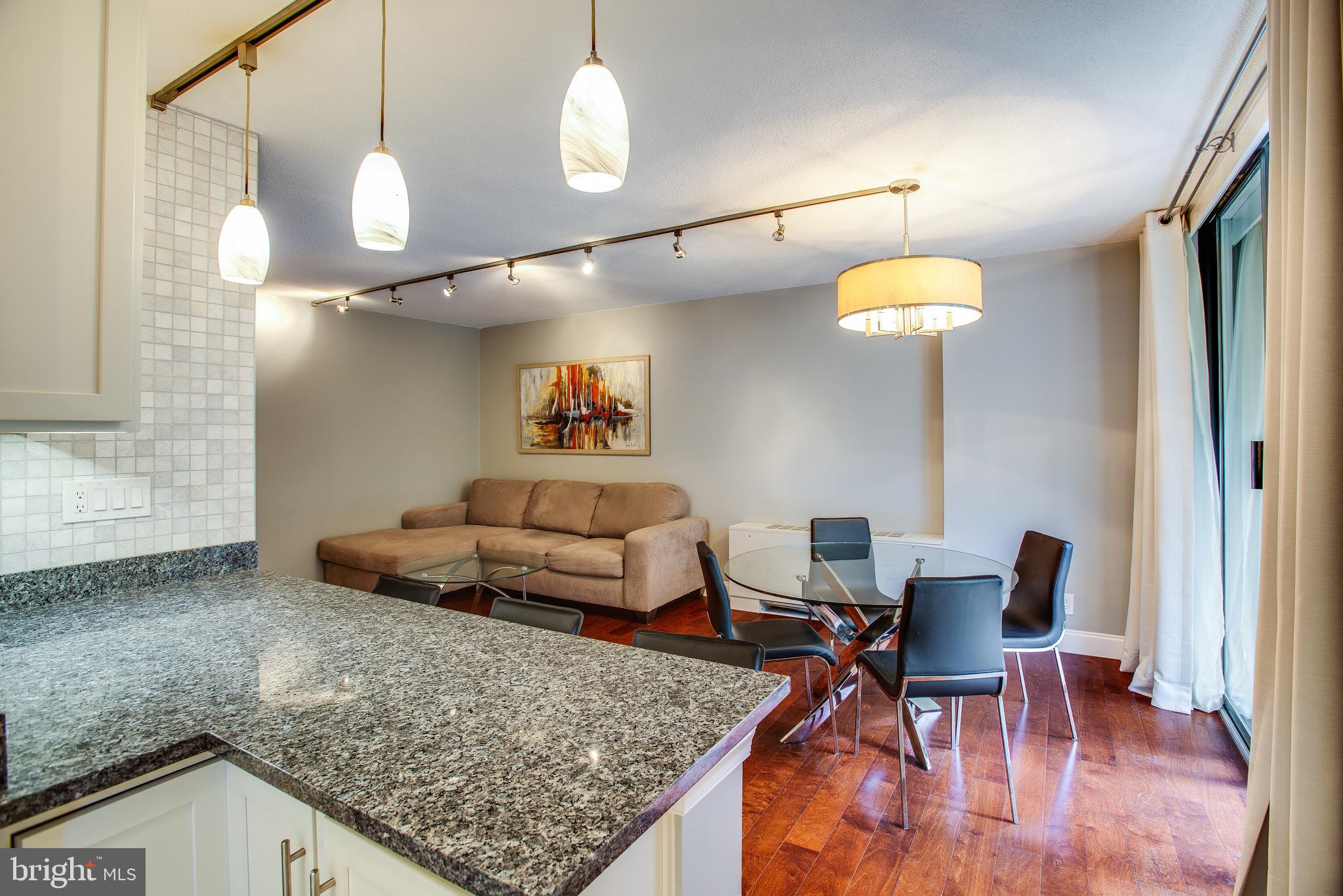 2201 L Street Northwest, Unit 500 Washington, DC 20037 - Photo 43 of 43 a living room with furniture and a chandelier
