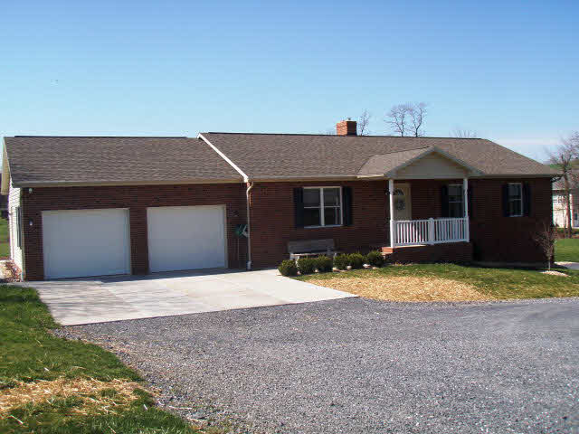 101 Bridgewater Road Bridgewater, VA 22812 - Photo 1 of 1 a front view of a house with a yard and garage