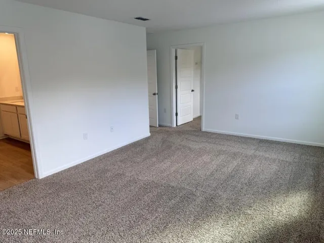 a white toilet sitting next to a wooden floor