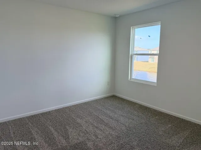 a sign of golf club on a wall under a large tree