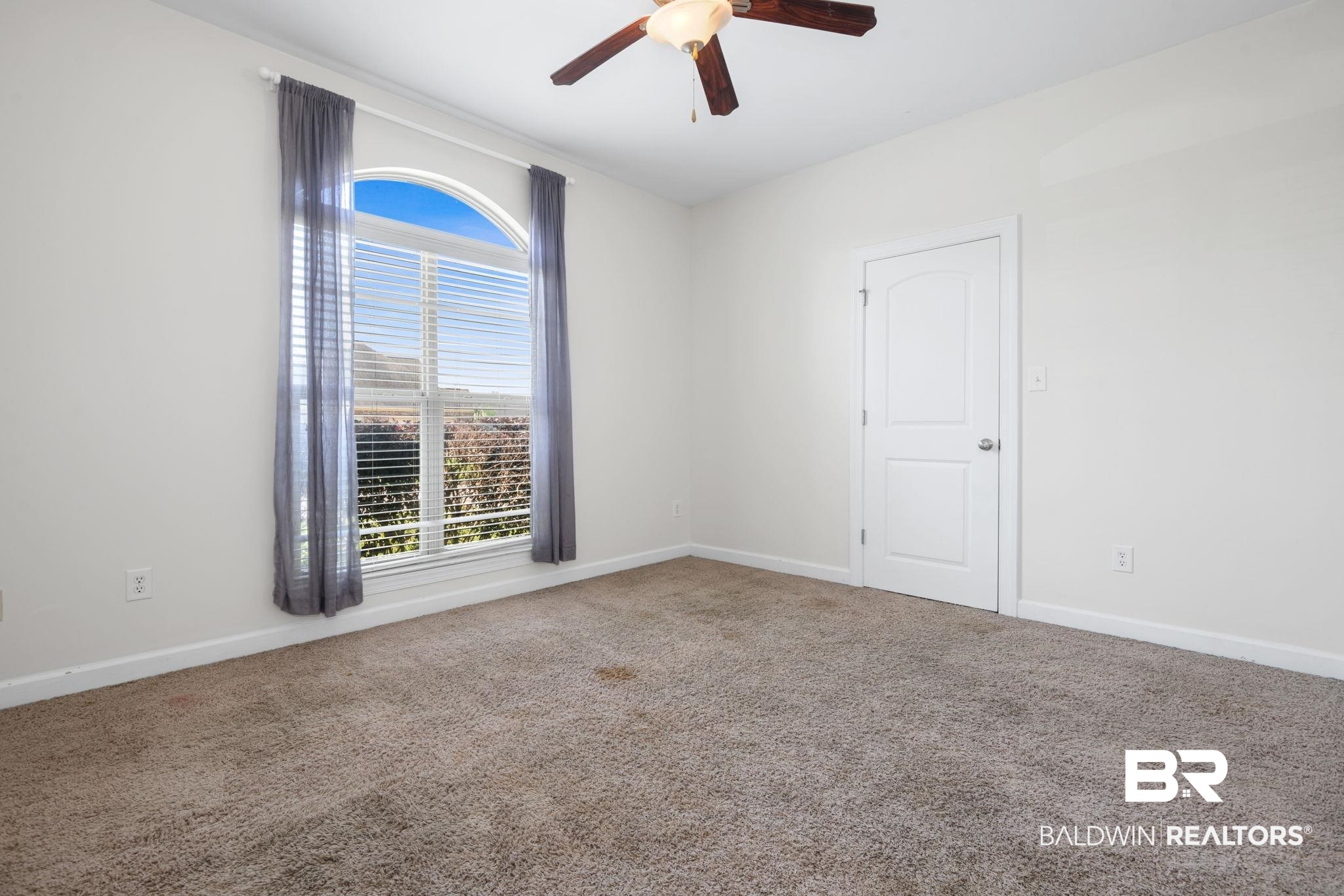9730 Harmony Ridge Circle West Semmes, AL 36575 - Photo 22 of 38 Carpeted empty room with a ceiling fan and baseboards