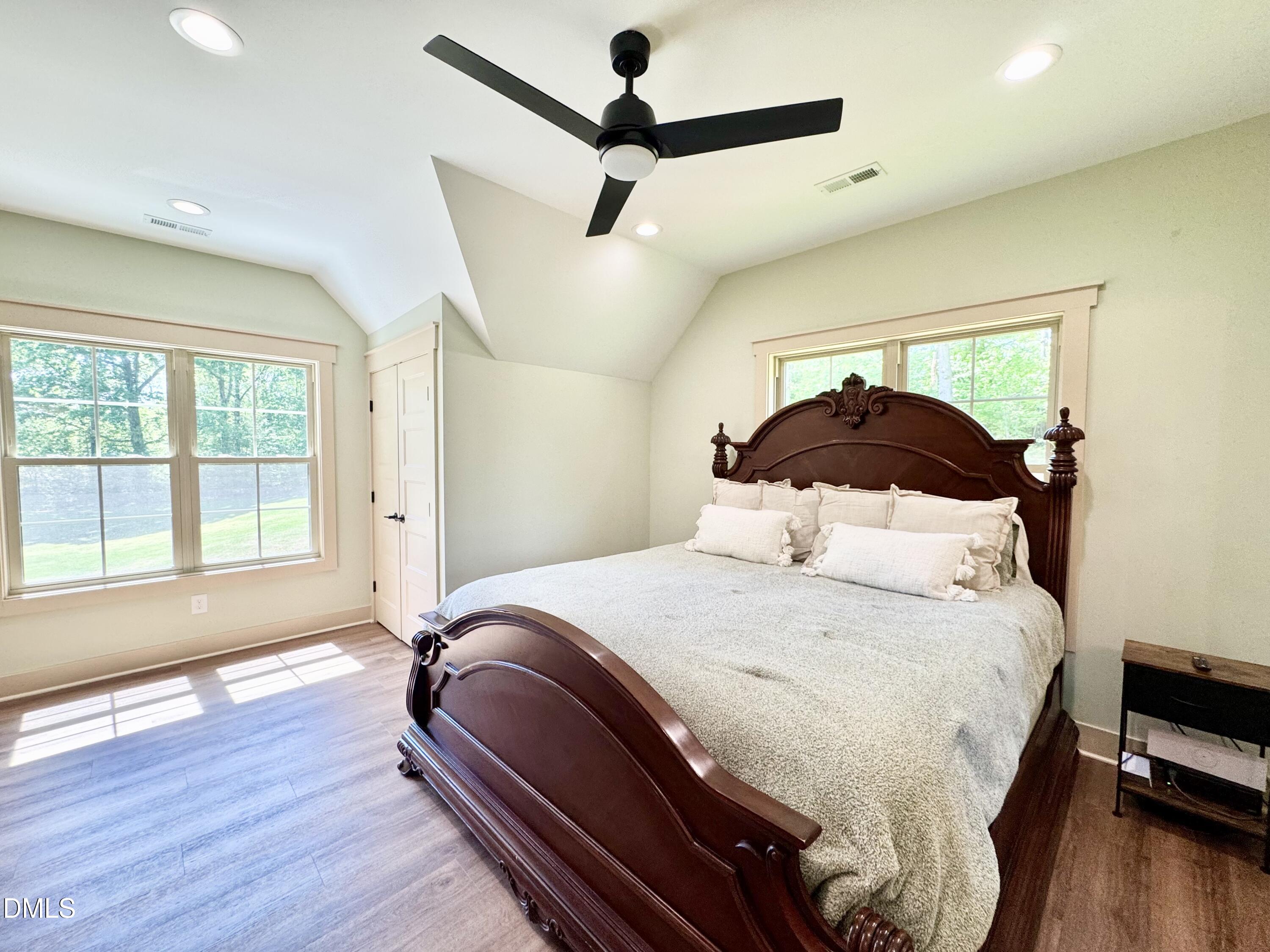 254 Fairway Drive Roxboro, NC 27574 - Photo 15 of 28 a bedroom with a bed and wooden floor