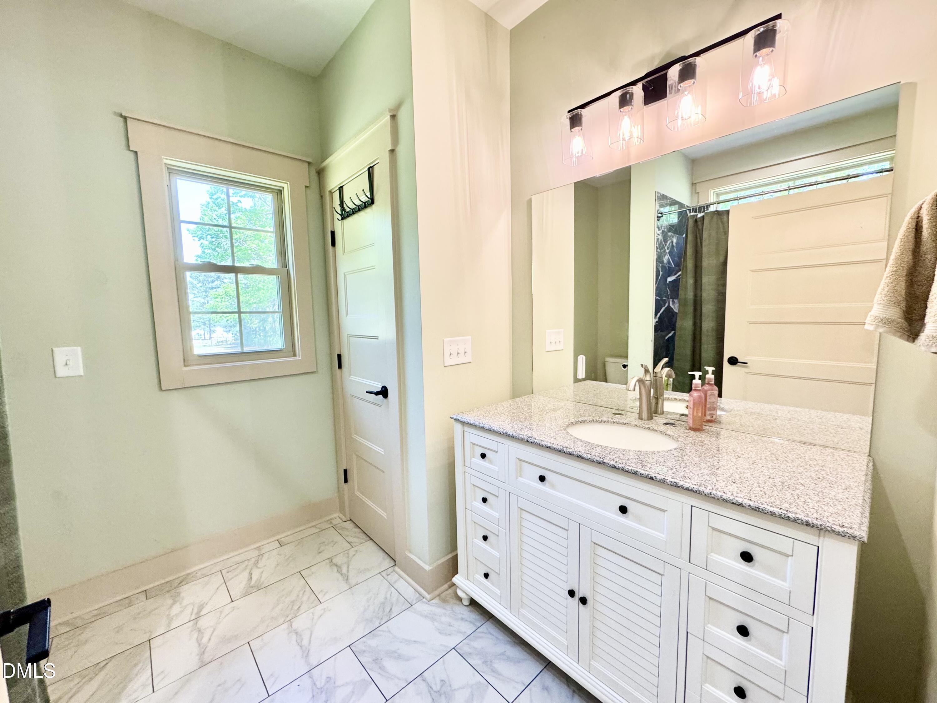 254 Fairway Drive Roxboro, NC 27574 - Photo 18 of 28 a bathroom with a granite countertop sink a mirror and a