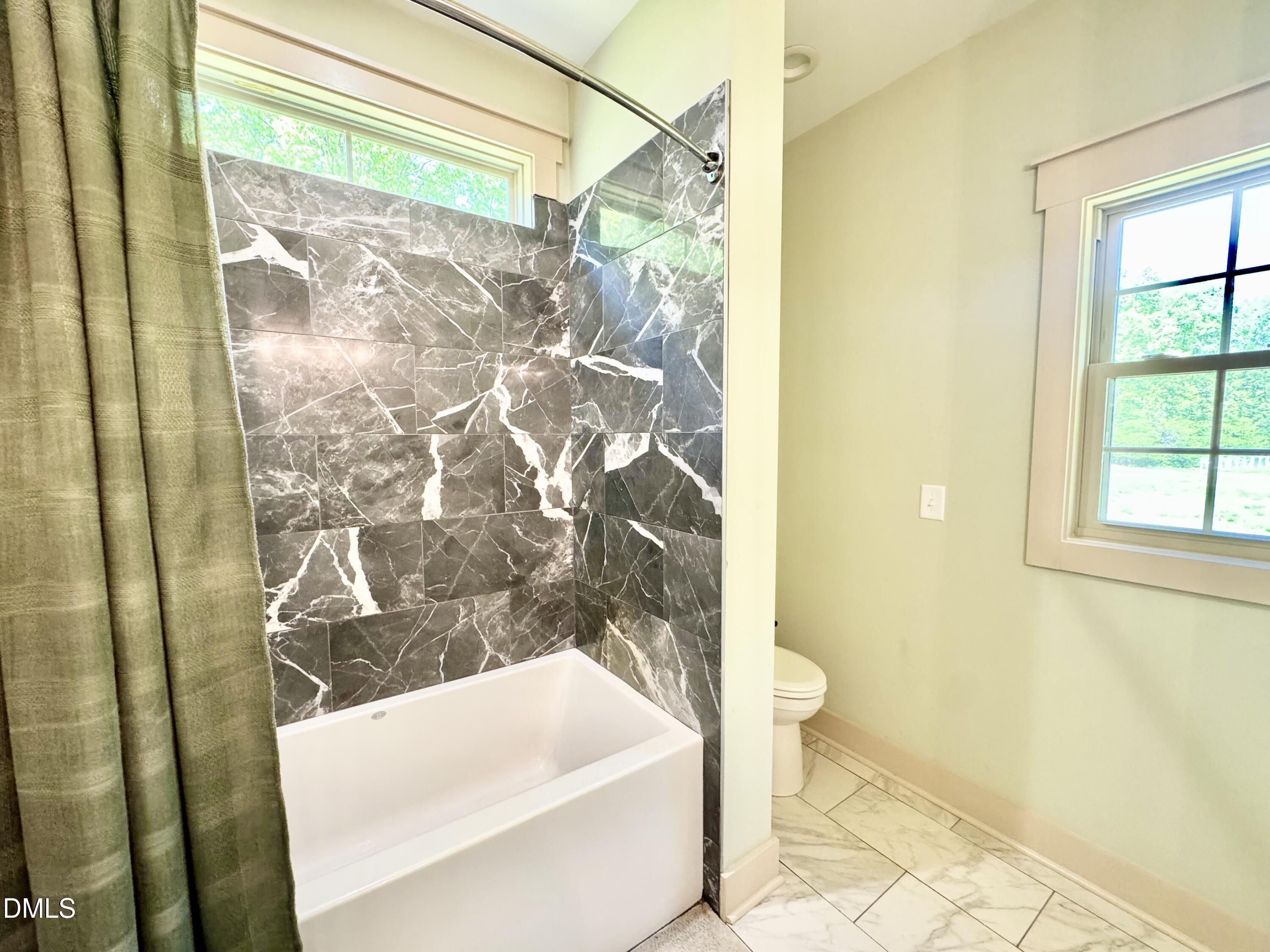 254 Fairway Drive Roxboro, NC 27574 - Photo 19 of 28 a bathroom with a bathtub and shower