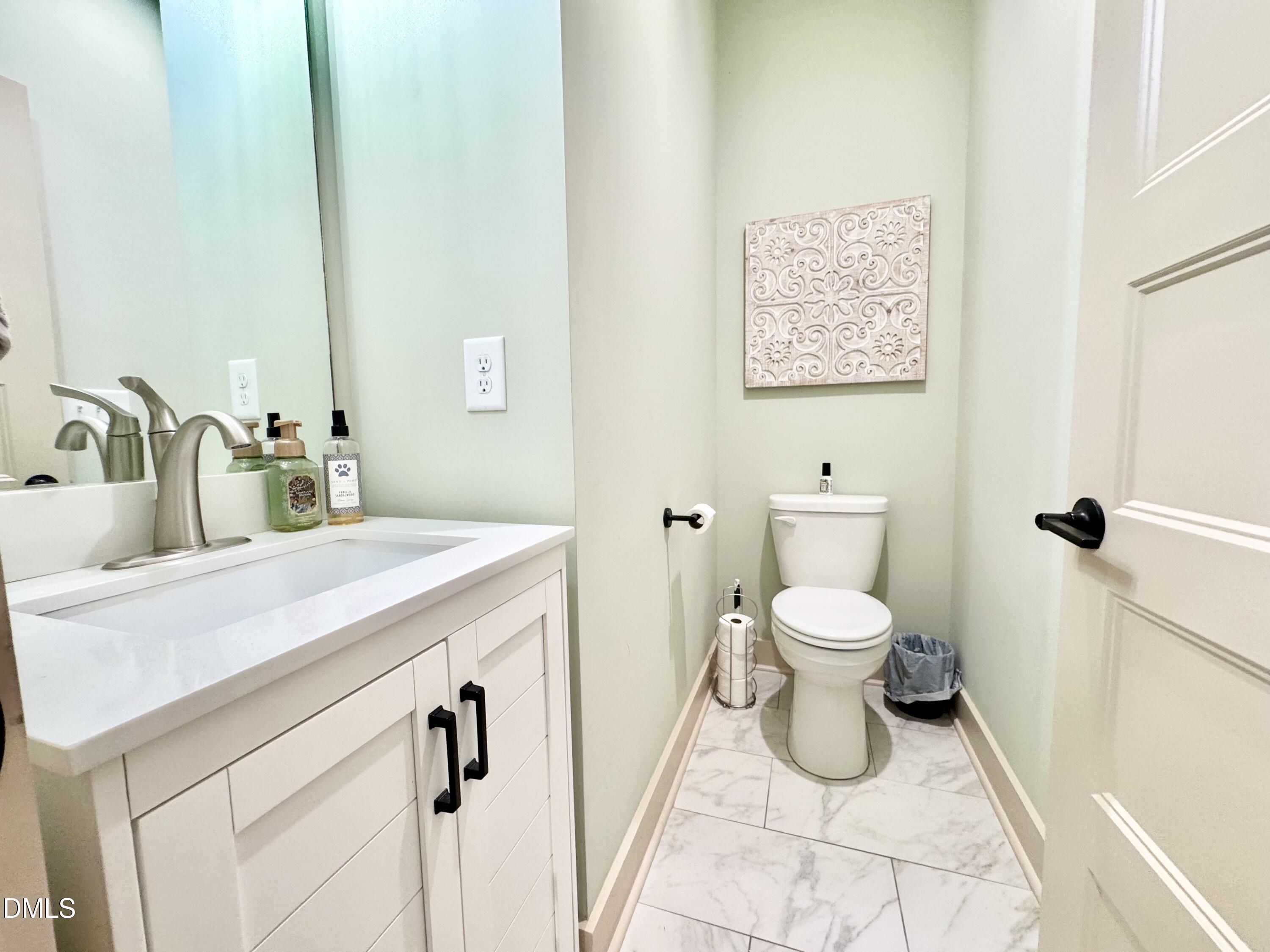 254 Fairway Drive Roxboro, NC 27574 - Photo 22 of 28 a bathroom with a toilet sink and mirror