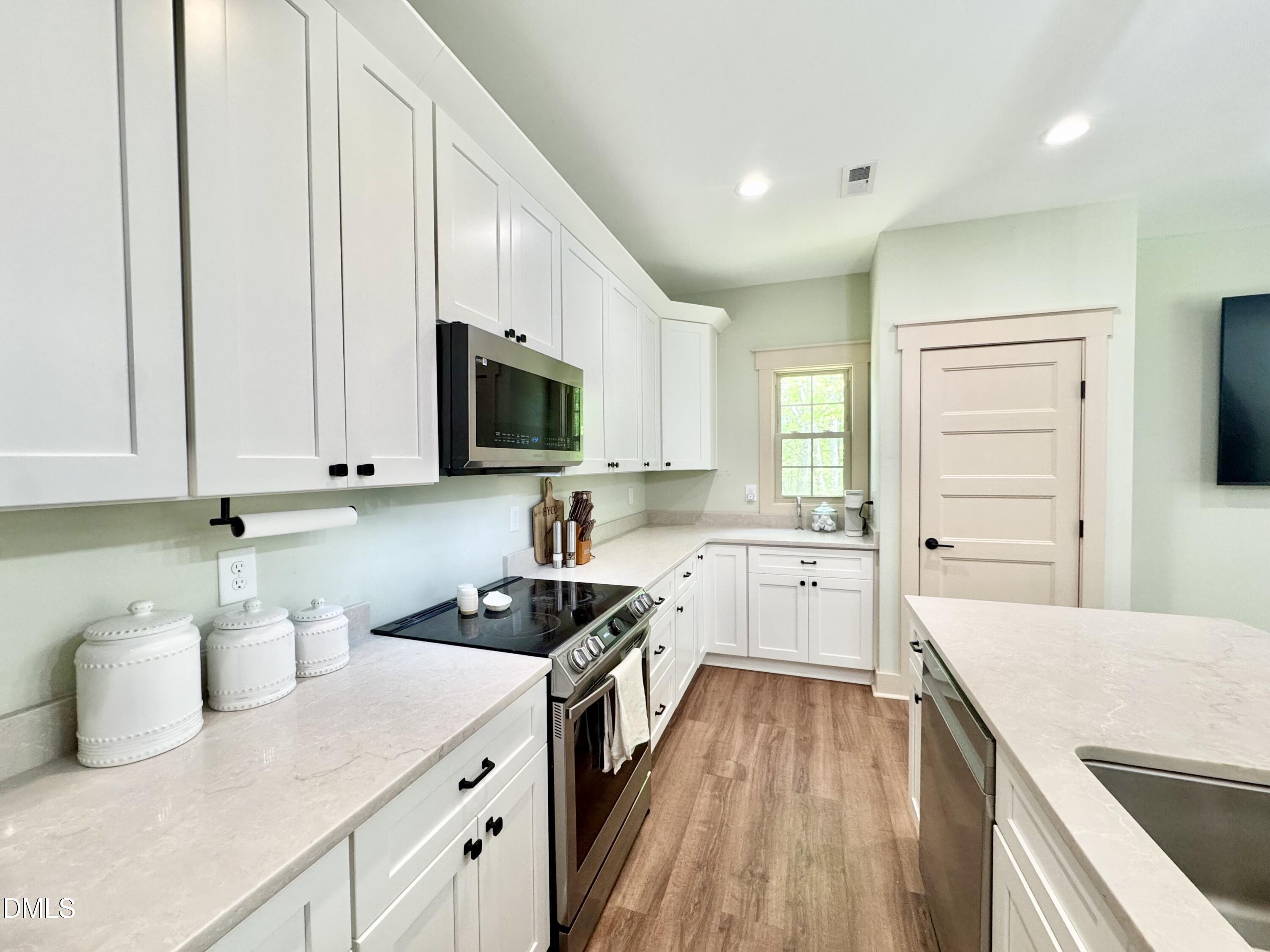 254 Fairway Drive Roxboro, NC 27574 - Photo 8 of 28 a kitchen with a sink stove top oven and cabinets