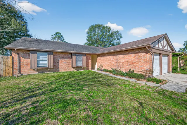 a view of a house with yard and a garden
