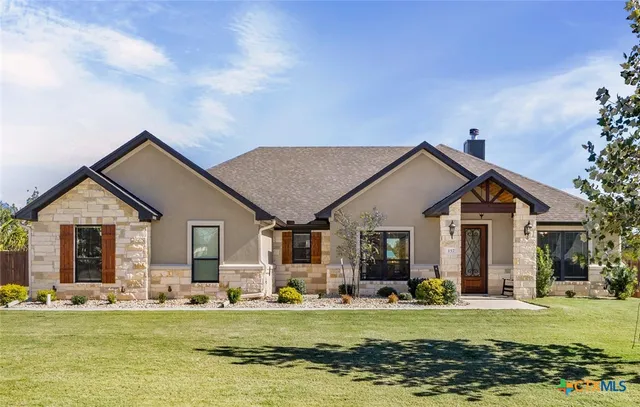 a front view of a house with a garden