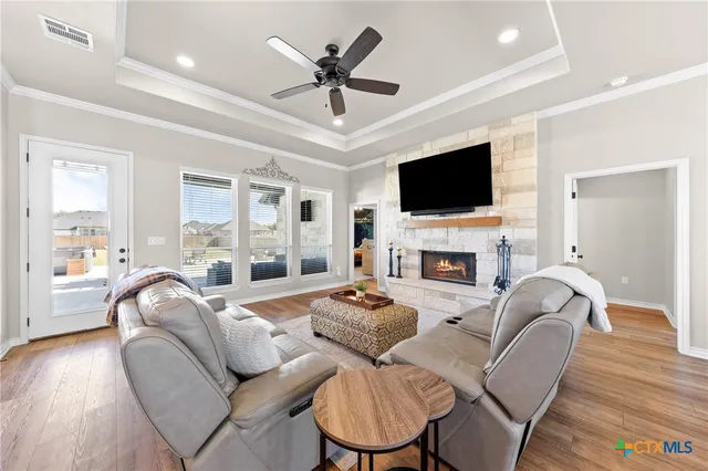 a kitchen with stainless steel appliances a white table chairs and a refrigerator