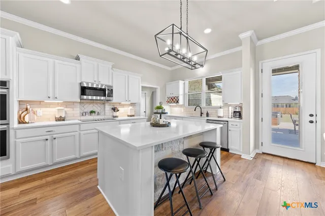 a kitchen with a sink stove and microwave