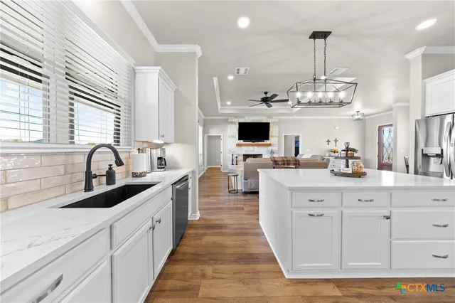 a kitchen with stainless steel appliances granite countertop a sink and a granite counter tops