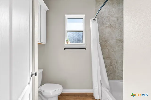 a bedroom with bed and a flat screen tv